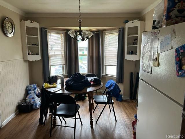 dining area featuring hardwood / wood-style floors, a notable chandelier, and a wealth of natural light