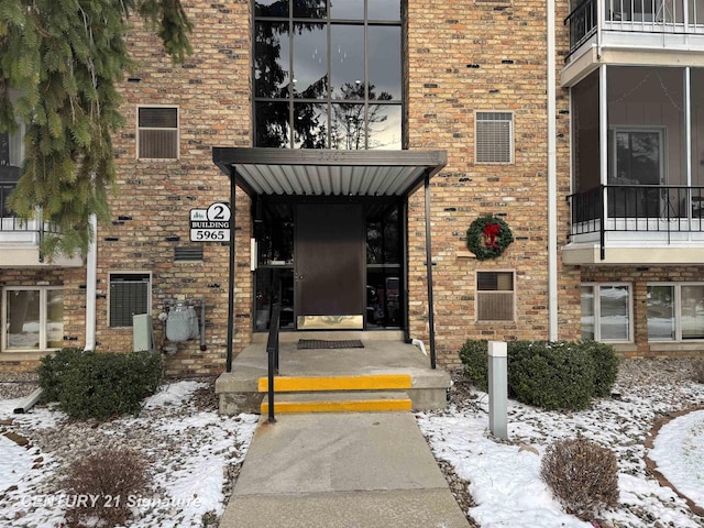 view of snow covered property entrance