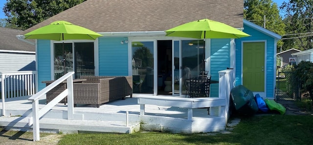 rear view of property featuring a deck