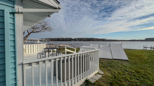 deck with a yard and a water view