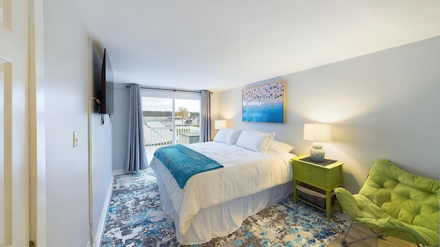 bedroom featuring access to outside and floor to ceiling windows