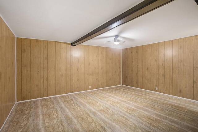 empty room featuring wood walls, beamed ceiling, and wood-type flooring