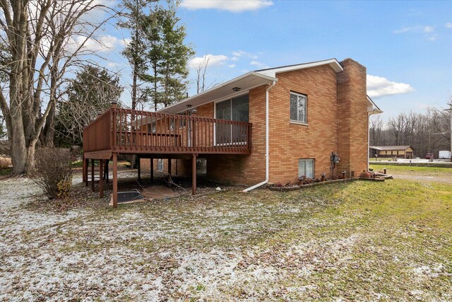 back of house with a deck and a yard