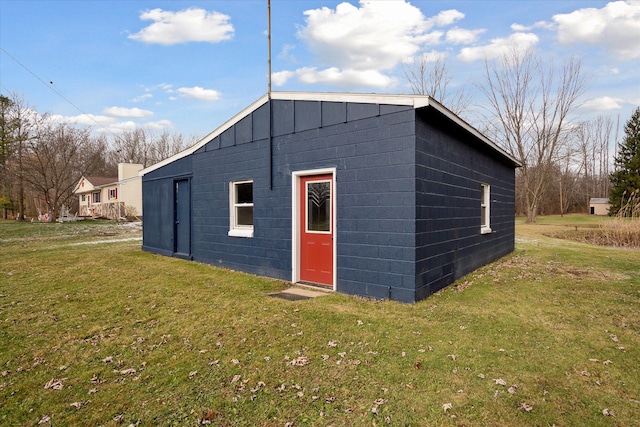 view of outdoor structure featuring a lawn