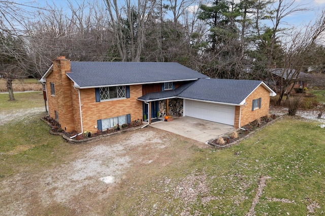 raised ranch with a garage and a front yard