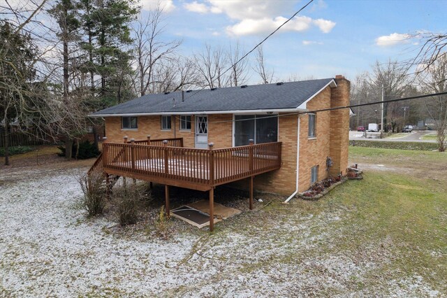 rear view of property featuring a deck