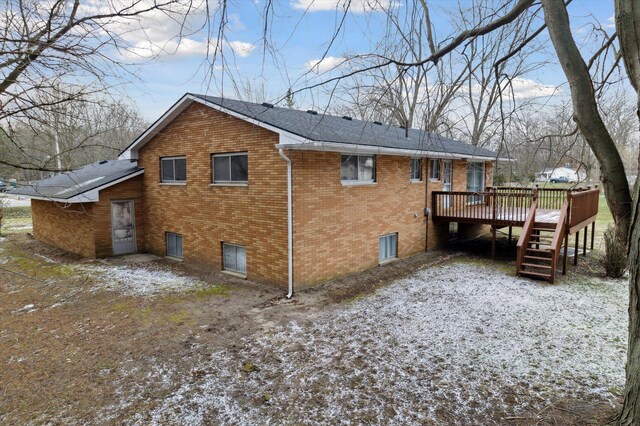 back of property featuring a deck