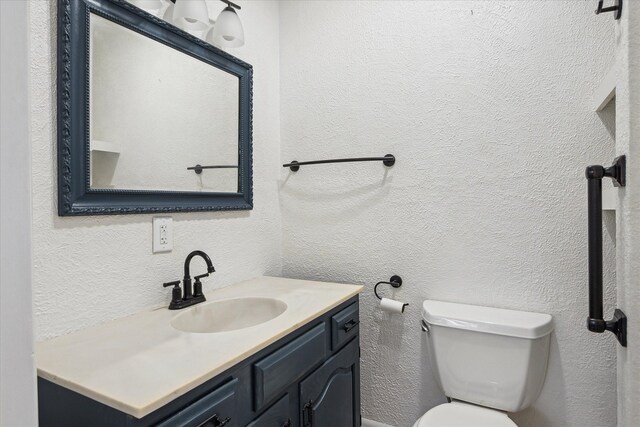 bathroom featuring toilet and vanity