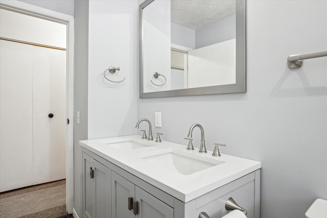 bathroom featuring vanity and a textured ceiling