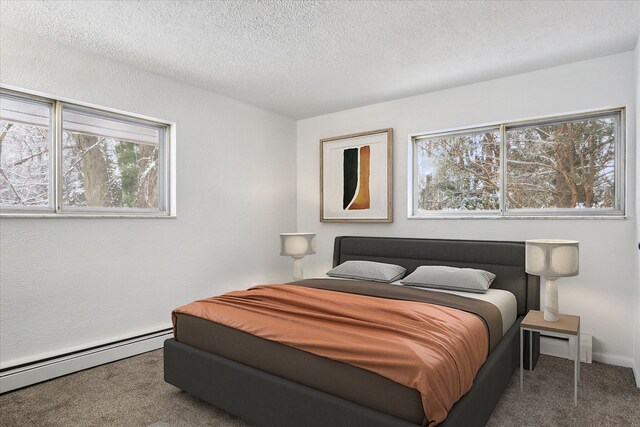 carpeted bedroom featuring a baseboard radiator and a textured ceiling