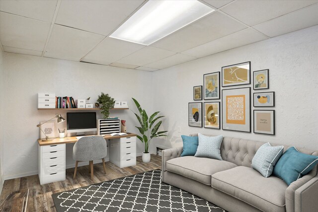 office area with hardwood / wood-style flooring and a drop ceiling