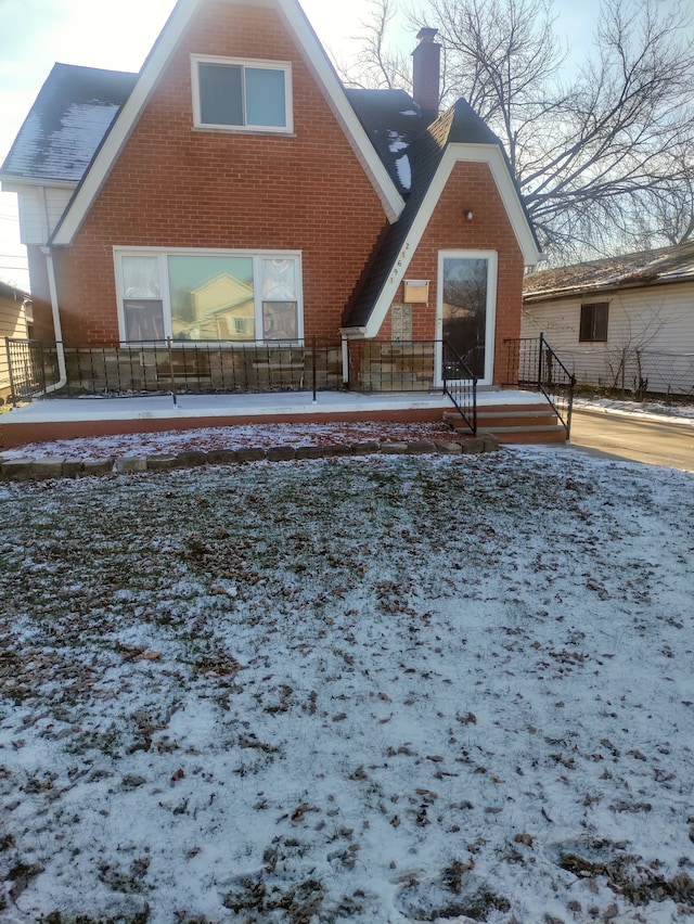 view of snow covered rear of property