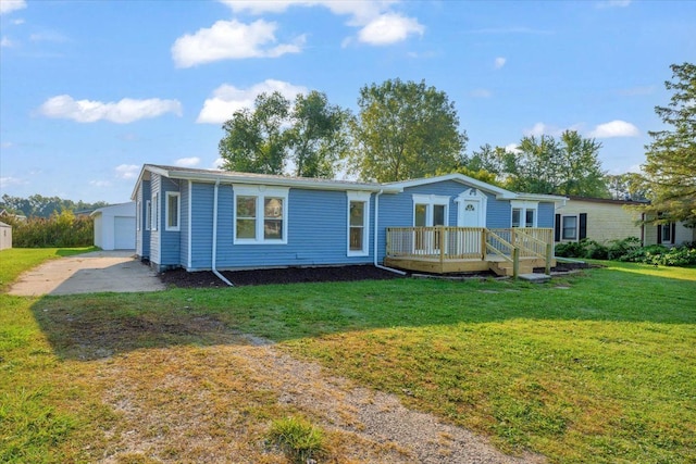 manufactured / mobile home with a front lawn, a garage, an outdoor structure, and a deck