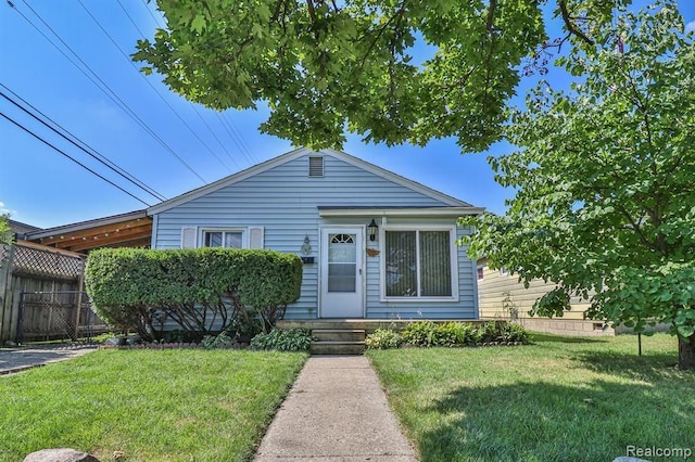 bungalow-style house featuring a front yard