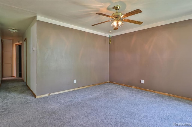 spare room featuring carpet flooring, ceiling fan, and ornamental molding