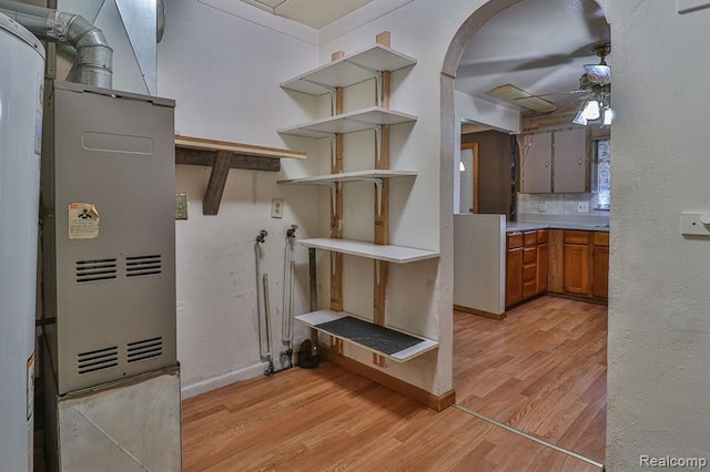 kitchen featuring backsplash, light hardwood / wood-style flooring, and ceiling fan