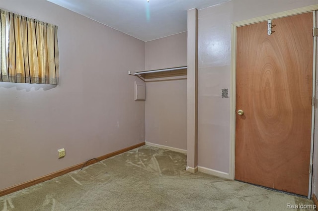 laundry area featuring light colored carpet