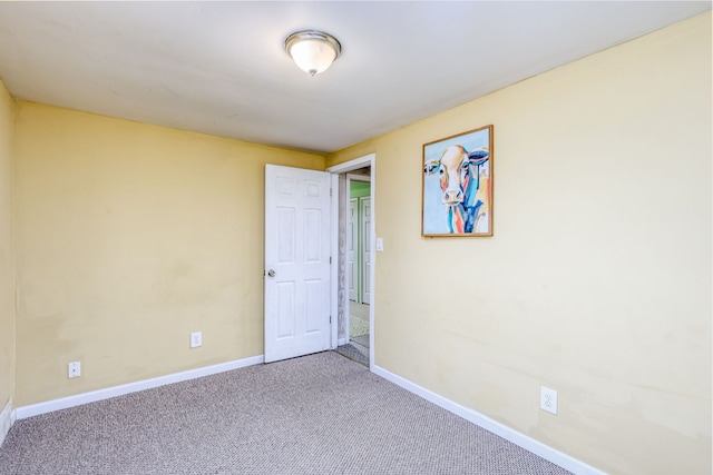 unfurnished room featuring carpet flooring