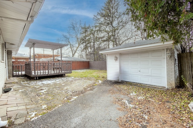 view of yard with a garage, an outdoor structure, and a wooden deck