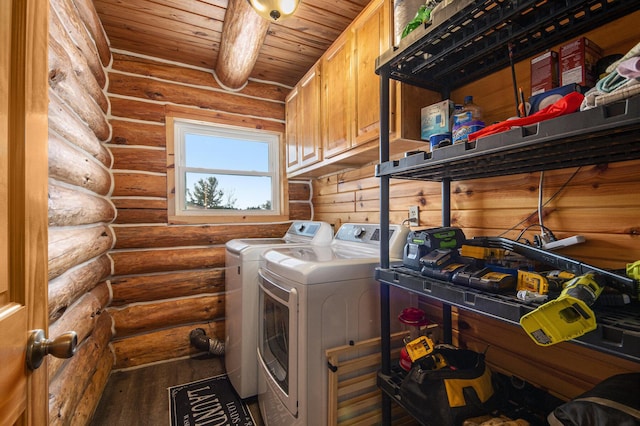 laundry area featuring cabinets, rustic walls, wood-type flooring, wood ceiling, and washing machine and clothes dryer