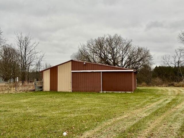 view of outbuilding featuring a yard