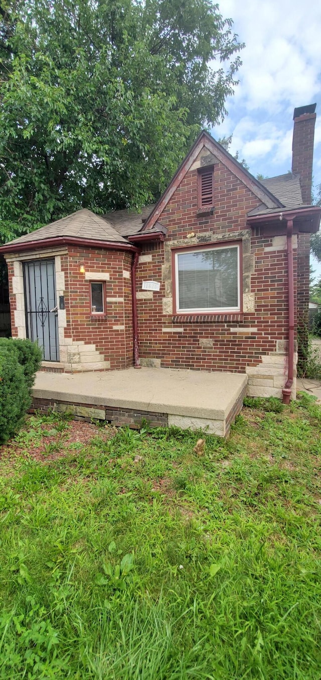 11828 College St, Detroit, MI 48205 - rear view of house featuring a lawn