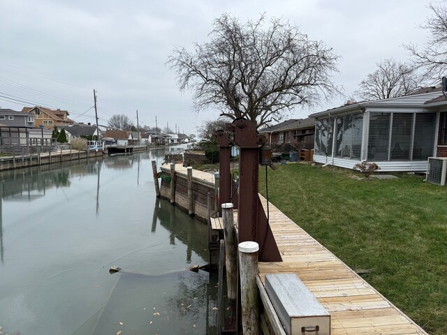 view of dock with a lawn, a water view, and cooling unit