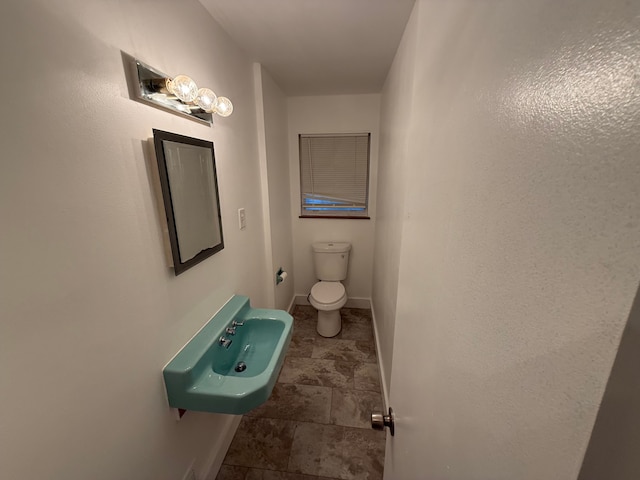 bathroom featuring sink and toilet