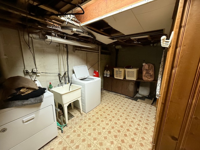 clothes washing area featuring washer and dryer, laundry area, and light floors