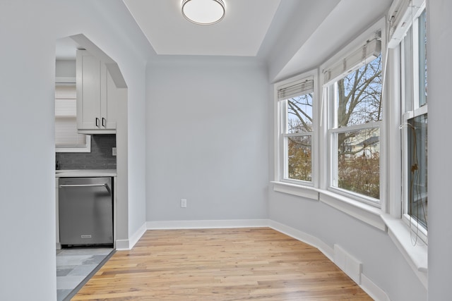 unfurnished dining area with plenty of natural light and light hardwood / wood-style flooring