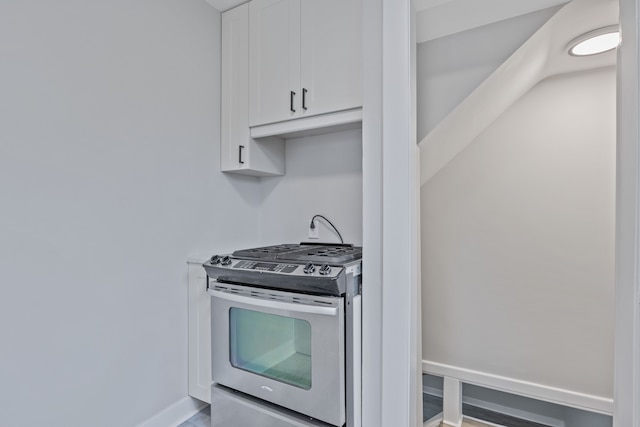 kitchen featuring white cabinets and stainless steel range with gas cooktop