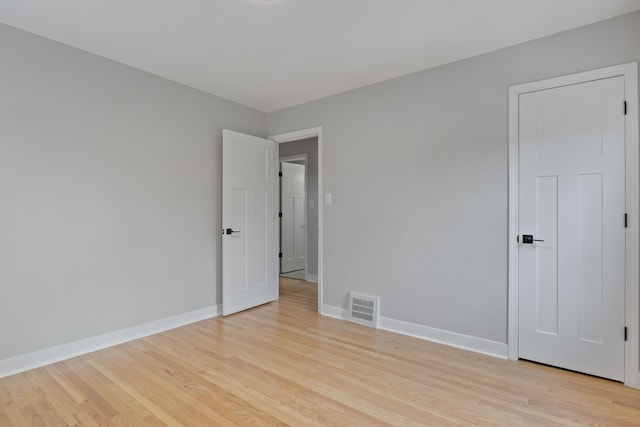 empty room with light hardwood / wood-style floors