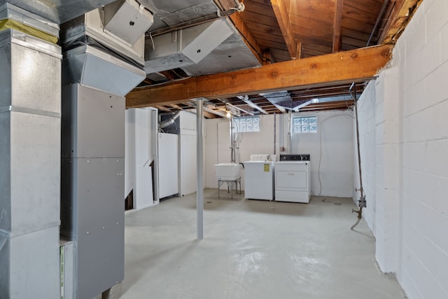 basement with separate washer and dryer and sink