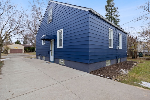 view of property exterior with an outdoor structure and a garage