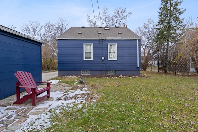 back of property featuring a patio area and a yard