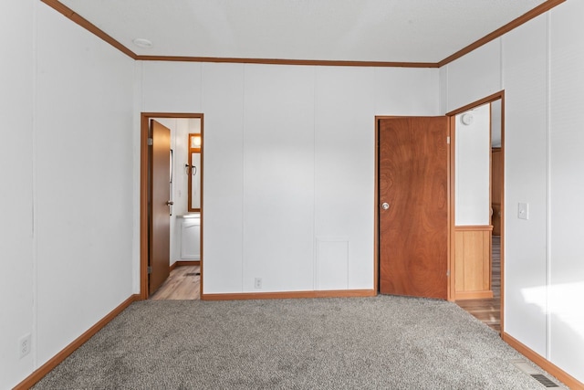 spare room featuring light carpet and ornamental molding