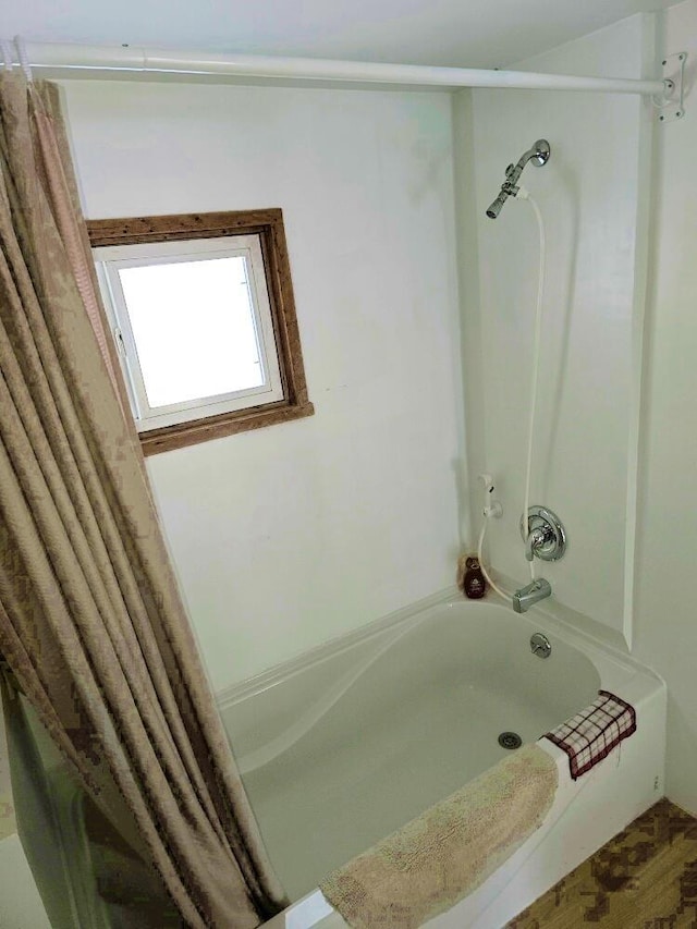 bathroom with shower / bath combo with shower curtain