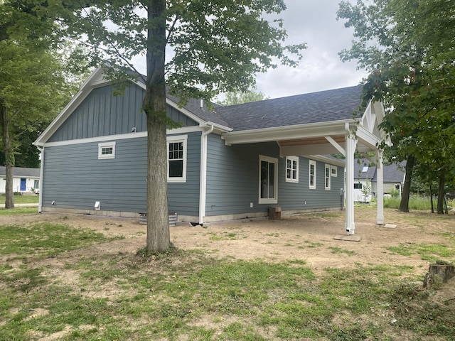 back of property featuring a lawn