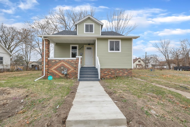 bungalow-style house featuring a front yard