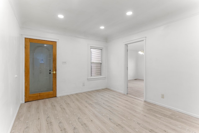 unfurnished room featuring light hardwood / wood-style floors and ornamental molding