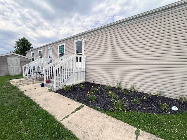 entrance to property with a lawn