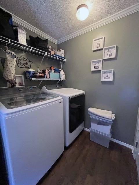 clothes washing area featuring washer and dryer, dark hardwood / wood-style flooring, a textured ceiling, and crown molding