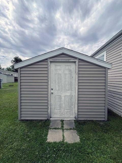 view of outbuilding with a yard