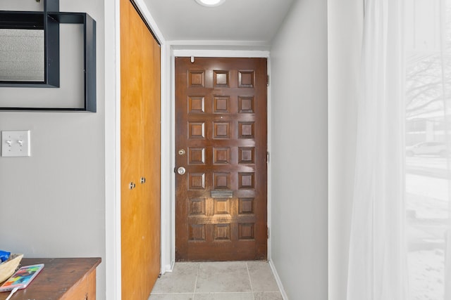 doorway featuring light tile patterned flooring