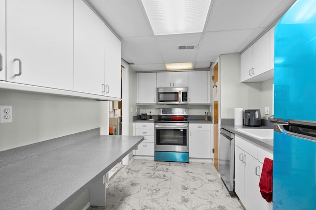 kitchen featuring stainless steel appliances, white cabinetry, and sink