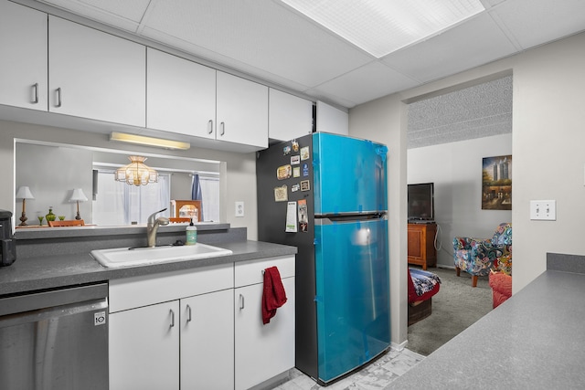 kitchen with dishwasher, white cabinetry, fridge, and sink