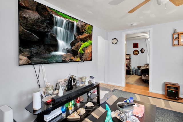 living room featuring hardwood / wood-style floors and ceiling fan