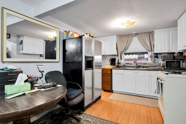 kitchen featuring white cabinets, sink, stainless steel appliances, and light hardwood / wood-style flooring