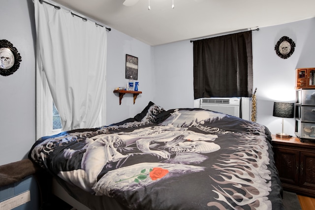 bedroom with ceiling fan and cooling unit