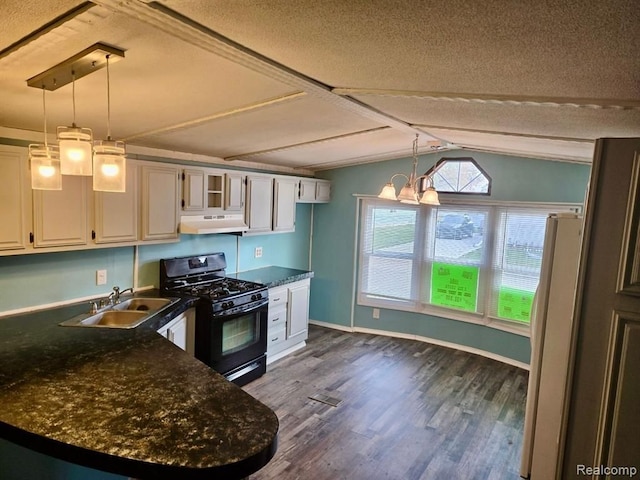 kitchen featuring black gas range oven, dark wood-type flooring, white cabinetry, and pendant lighting